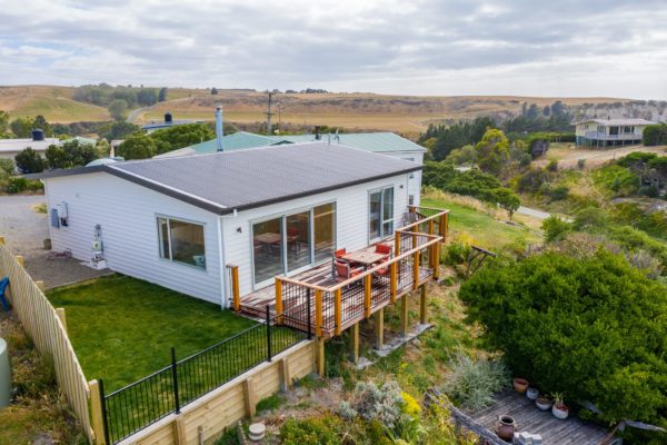 Drone photo of newly renovated bach with new exterior cladding and deck