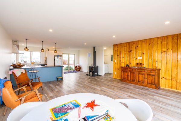 Completed renovation project by Code Construction showing new kitchen, flooring fire place and living space