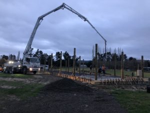 Concrete pump on site in Loburn North Canterbury. Pumping concrete onto prepared reinforced steel foundation