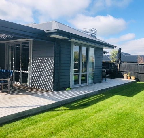 New build designed and built by Code Construction with linear weatherboard, hardwood decks and louvered roof, Christchurch