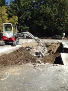 Digging out swimming pool in preparation for outdoor renovation project