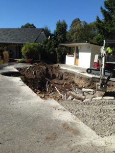 Digger removing old pool footprint to make room for new fibreglass swimming pool unit, North Canterbury