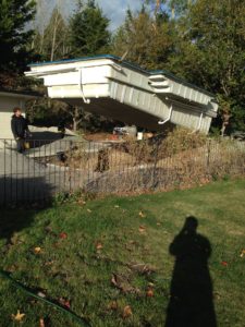 Crane removing old pool in preparation for new pool and outdoor renovation