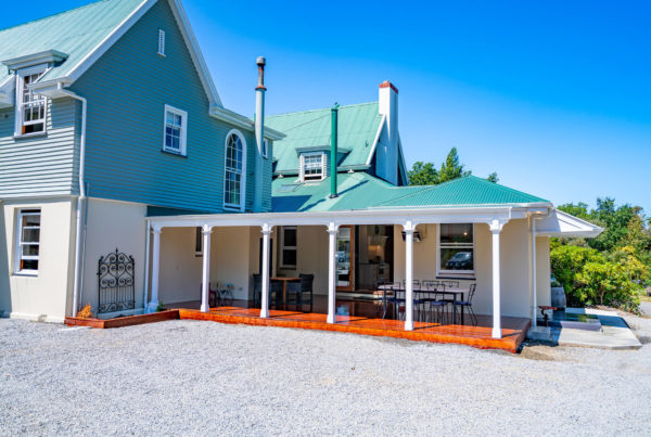 New renovation completed by Code Construction includes new outdoor area with hardwood deck and louvre system