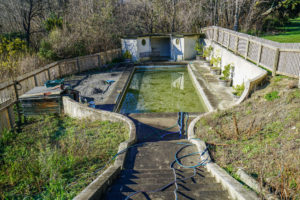 Photo of old derelict pool before repairs and renovation by Code Construction