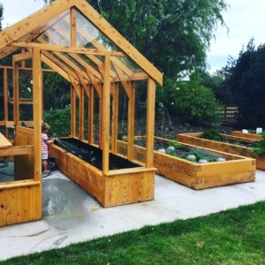 Raised veggie gardens with macrocarpa sleepers and bespoke glass house project. completed by Code Construction in North Canterbury