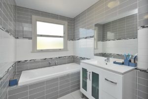 Newly renovated bathroom by Code Construction. Full wall to floor tiling