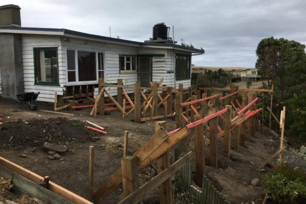 Before photo of existing house. Piles in ready for renovation extension by Code Construction