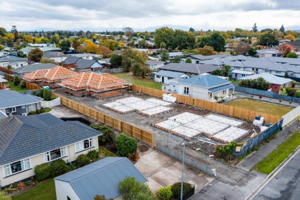 Two foundations boxed and ready for pouring and two frames and roof trusses up for four new builds by Code Construction