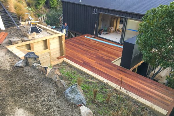 Photo looking down on new hardwood decking project including retaining wall and landscaping