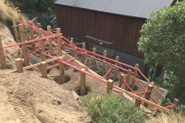 Posts in the ground ready to be concreted in for retaining wall in Akaroa