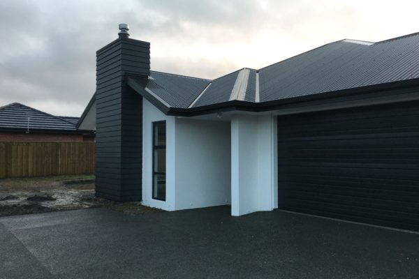 Exterior of new build with feature chimney completed by Code Construction