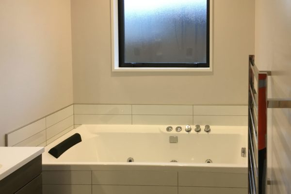 New bathroom in new build by Code Construction, includes spa bath