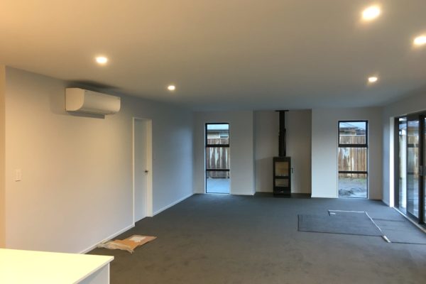 Photo of completed lounge with log burner in new build in Rangiora