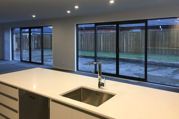 Photo from new kitchen in new build under construction. Double glazing installed and landscaping underway