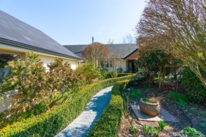 Photo of garden path and landscaping before renovation by Code Construction