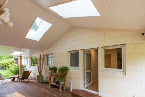 Completed outdoor renovation project featuring roof over outdoor area with two large skylight windows